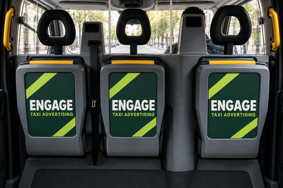 Engage posters on the backs of a taxi's folding passenger seats